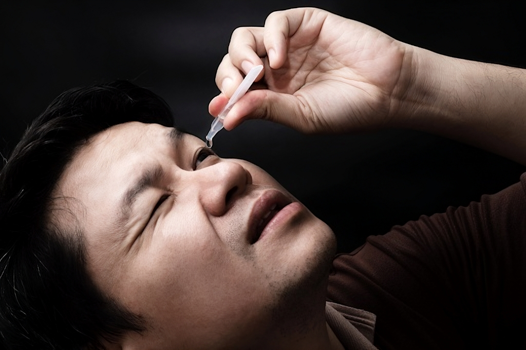 a guy using Preservative-free lubricating eye drops